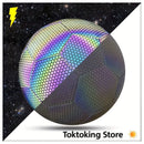 Purple Glimbo goalkeeper ready to kick reflective soccer ball with powerful shot in city park at night