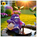 Amoeba King mascot pouring water into solar bird bath fountain at sunrise with colorful birds gathering around