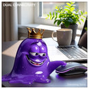 Amoeba mascot sitting next to rechargeable wireless mouse on neon background